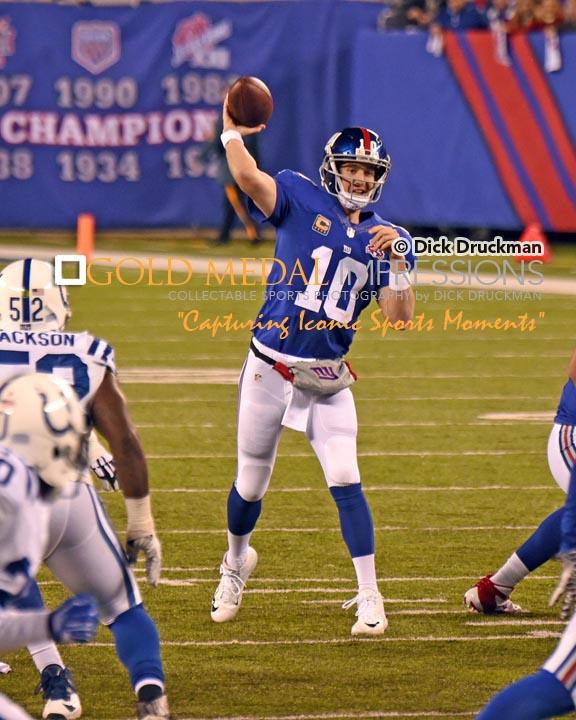 New York Giants quarterback, ELI MANNING, throws a pass in the first quarter against the Indianapolis Colts. MANNING completed 27 of 52 passes for 359 yards and 2 touchdowns. Despite his efforts, the Giants lost 40-24.