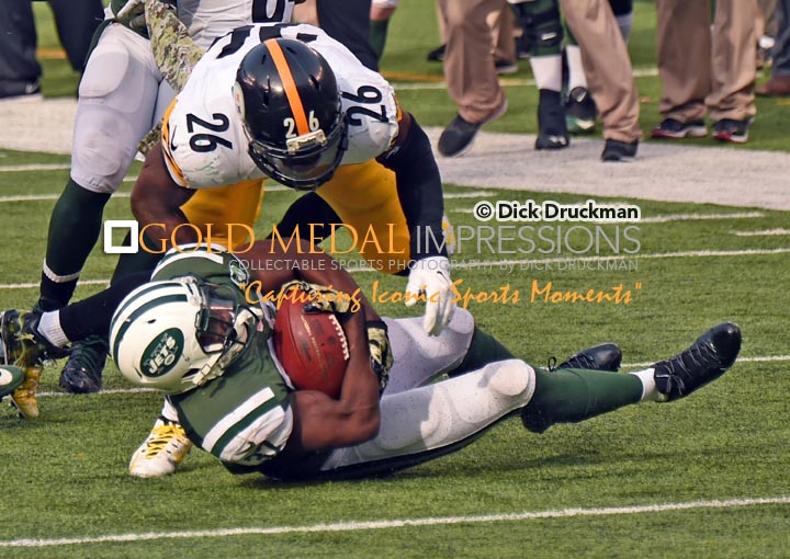 New York Jets backup safety, JAIQUAWN JARRETT, intercepts pass from Pittsburgh Steelers quaterback Ben Roethlisberger in the second quarter and is tackled by Steelers running back LE VEON BELL. JARRETT led the Jets to a 20-13 victory.