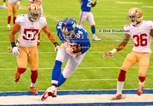 New York Giants tight end, LARRY DONNELL, scores the New York Giants first and only touchdown in the frst quarter as San Framcisco 49ERS defenders MICHAEL WILHOITE(57) and DONTAE JOHNSON(36)attempt to defend. The 49ERS went on to win 16-10.