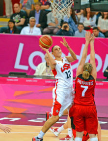 USA Diana Taiurasi drives for a score against Canada in the first quarter as defender Pilypaitis attempts to block the shot. Taurasi was high scorer with 15 points and led her team to a 91-48 victory in the quarter final game,(AP PHOTO/DICK DRUCKMAN)