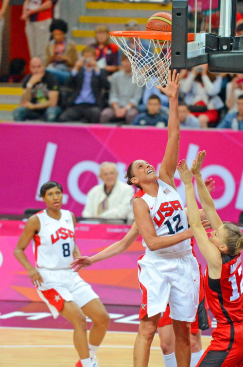 USA basketball star Diana Taurasi scores against Canada in the first quarter as defender L. Murphy attempts to block the shot. Taurasi scored 15 points leading the USA team to a 91-48 victory.(AP Photo/Dick Druckman)