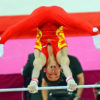 China gymnast, Kai Zou, does a handstand on the horizontal bar in the men's artistic gymnastics final in the North Greenwich Arena. China won the gold medal in the team competition.