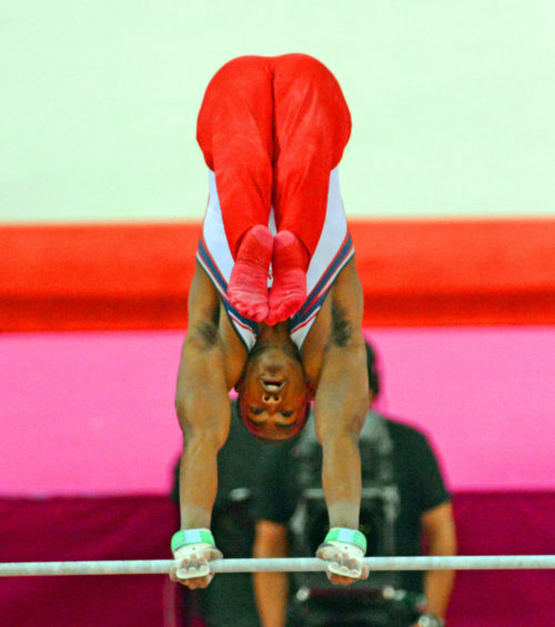 USA gymnist John Orozco, does a headstand on the horizontal bar in the team competition. The USA performed poorly and finished 5th.