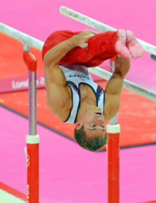 USA gymnist, Samuel Mikulak , dismounts from the parallel bars in the team competition of the London Olympics. The US finished fifth while China, Japan, and Great Britain took the gold, Silver, and Bronze, respectively.(
