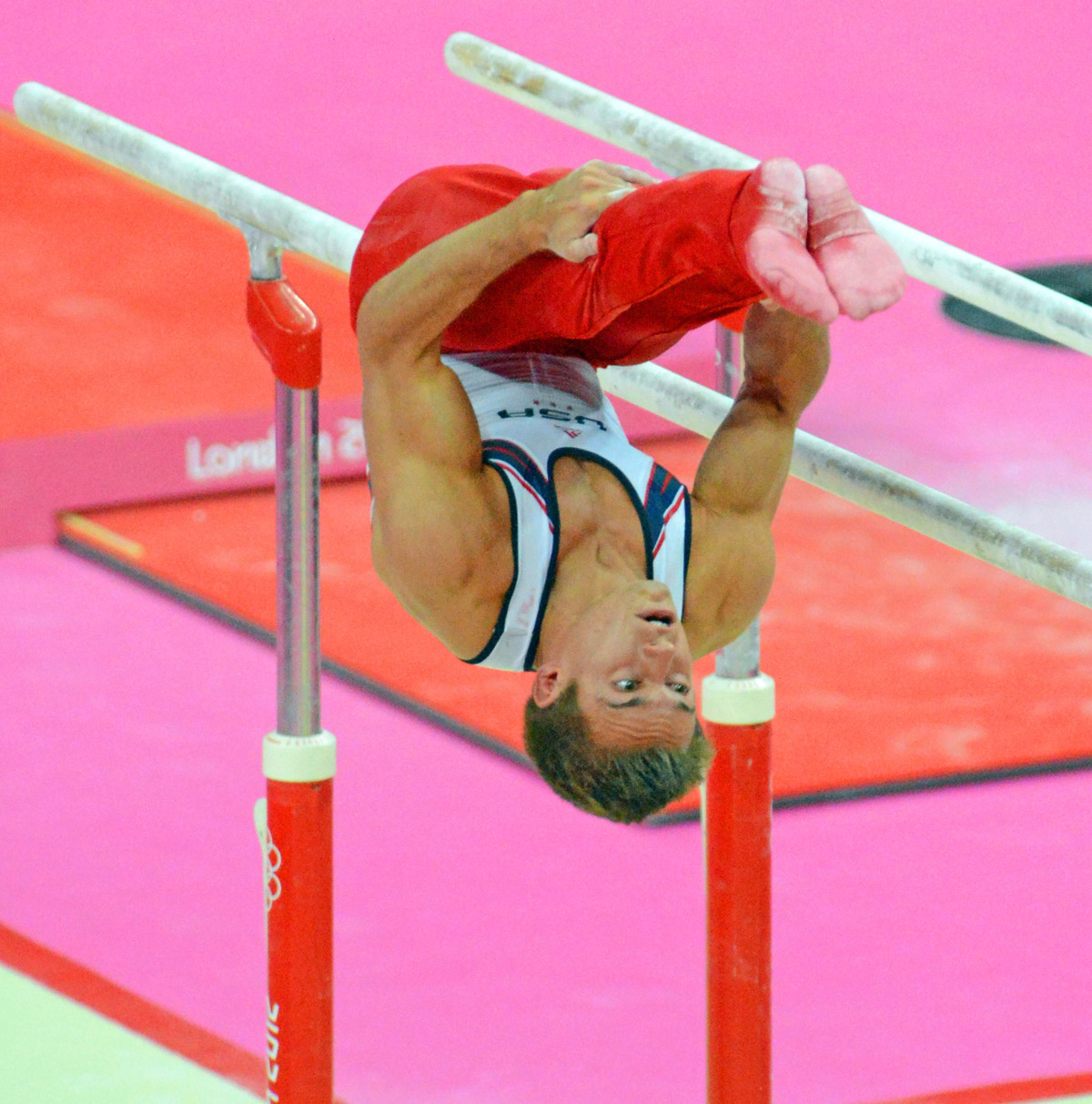 USA gymnist, Samuel Mikulak , dismounts from the parallel bars in the team competition of the London Olympics. The US finished fifth while China, Japan, and Great Britain took the gold, Silver, and Bronze, respectively.(