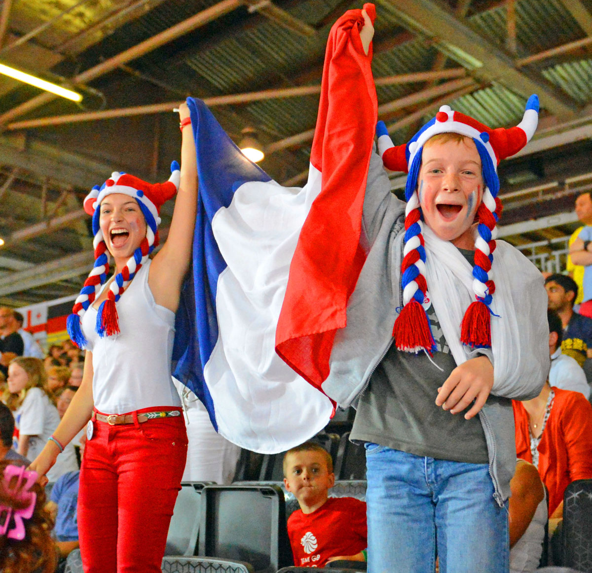 Avid fans, Lora and David Burgun, from Strasburg France, celebrate Lucie Decosse's gold medal victory in the women's Judo Finals in the London Olympics.(AP Photo/Dick Druckman)
