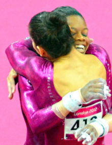 USA gymnist, Aly Reisman hugs her teammate Gabrielle(Gabby) Reisman during the women's individual all-around competition. Gabby went on to win the gold medal while Aly just missed winning a bronze medal.(AP Photo/Dick Druckman)