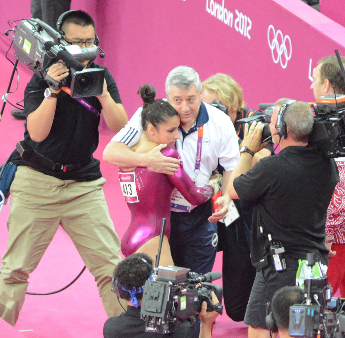 USA gymnist Aly Raisman hugs her coach after completing the vault exercise during the 2012 Summer Olympics in London England. Aly Reisman flips in her floor exercise.