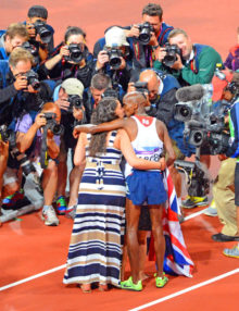 Great Britain 10,000 meter gold medal champion,Mo Farah, gets a kiss from his wife after winning the gold medal, which is caught by the press cameras.