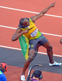 Jamaica running legend, Usain Bolt, flashes his signiture pose-- a lightening bolt after winning the Gold Medal in the men's 100meter event at the London Olympics. Usain set and olympic record of 9.63 seconds.(AP Photo/Dick Druckman)