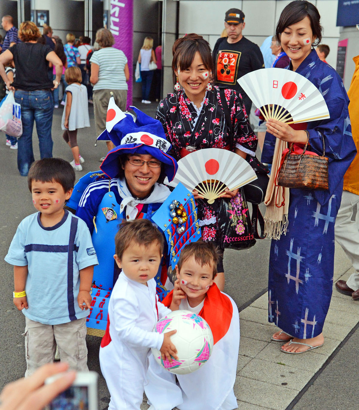 A Japanese family cheer on their team at Wembley Stadium in the Semi-final match against France. Japan won 2-1 and now face the United States team for the gold medal.(AP Photo/Dick Druckman)