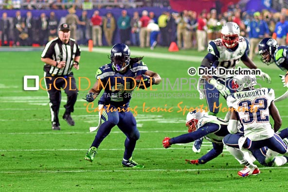 Seattle Seahawks running back, MARSHAWN LYNCH, runs for a first down against the New England Patriots in the third quarter of Super Bowl XLIX. The Patriots rallied to win 28-14.