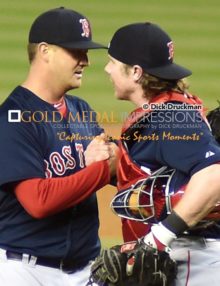 Boston Red Sox relief pitcher, STEVEN WRIGHT, is congratulated by his catcher, RYAN HANIGAN, after defeating the New York Yankees in the 19th inning 6-5. WRIGHT, who was originally slated to be the starting pitcher on Saturday, was called to relieve when the Red Sox ran out of relievers. WRIGHT pitched 5 innings, alloiwing 6 hits 2 runs with 1 strike out but getting the win and the save.(AP Photo/Dick Druckman)