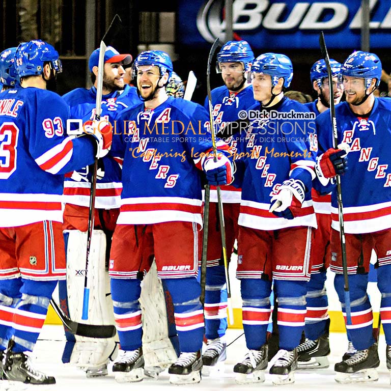 New York Rangers center, DEREK STEPAN, smiles with his teammates after scoring the winning goal in overtime in game 7 against the Washington Capitals at Madison Square Garden. The Rangers won 2-1.(AP Photo/Dick Druckman)