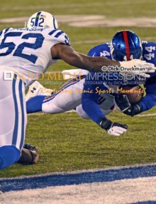 New York Giants running back, ANDRE WILLIAMS, leaps into the Indianapolis Colts endzone for a touchdown in the third quarter as Colts inside linebacker, D'QWELL JACKSON attempts to defend. The Colts went on to win 40-24.
