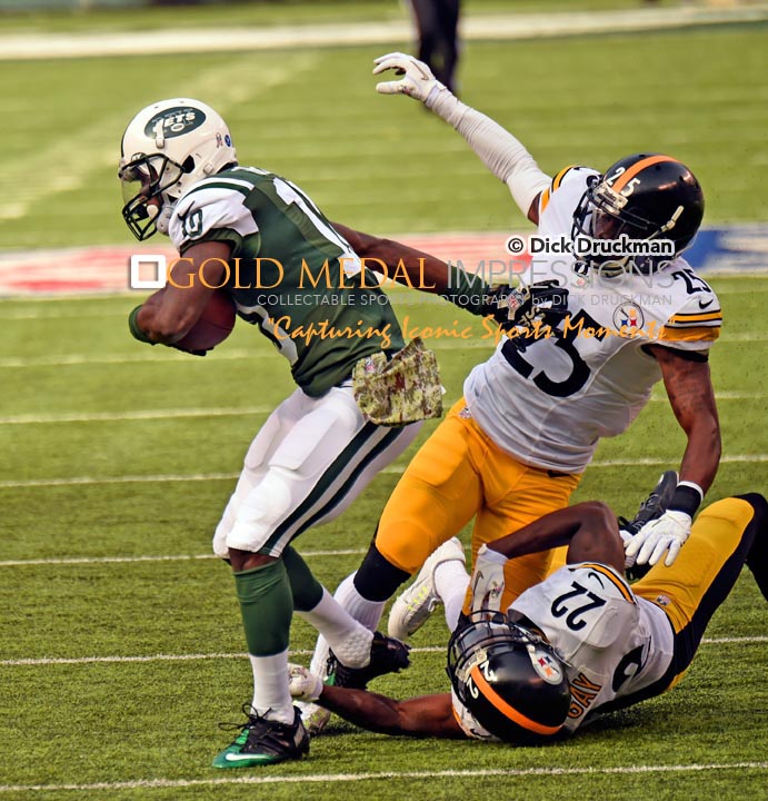 New York Jets wide receiver T.J. GRAHAM eludes the grasp of two Pittsburgh Steelers defenders, cornerbacks BRICE MCCAIN and WILLIAM GAY to score on a 67 yard pass in the first quarter at Met Life Stadium. The Jets went on to win 20-13.