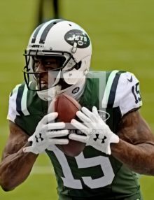 New York Jets wide receiver BRANDON MARSHALL scores his second touchdown on a 33 yard pass from quarterback Ryan Fitzpatrick in the second quarter against the New England Patriots giving the Jets a 17-3 lead. The Jets went on to win 26-20 in overtime.