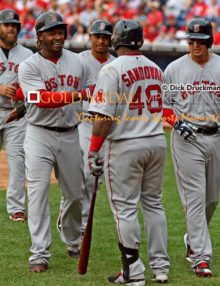 Boston Red Sox outfielder, HANLEY RAMIREZ, receives congratulations from PABLO SANDOVAL, MIKE NAPOLI, MOOKIE BETTS, and ALLEN CRAIG, after hitting a grand slam home run in the ninth inning, his second home run of the game. The Red Sox went on to win 8-0, spoiling Philadelphia Phillies home opener.(AP Photo/Dick Druckman)