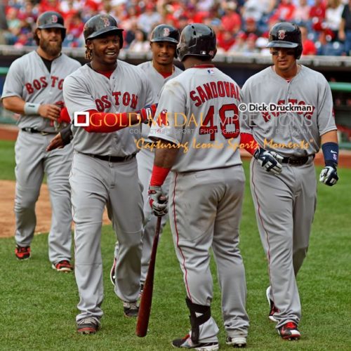 Boston Red Sox outfielder, HANLEY RAMIREZ, receives congratulations from PABLO SANDOVAL, MIKE NAPOLI, MOOKIE BETTS, and ALLEN CRAIG, after hitting a grand slam home run in the ninth inning, his second home run of the game. The Red Sox went on to win 8-0, spoiling Philadelphia Phillies home opener.(AP Photo/Dick Druckman)