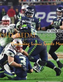 New England Patriots defensive end, ROB NINKOVICH, sacks RUSSELL WILSON in the fourth quarter of Super Bowl XLIX. The Patriots went on to win 28-24.