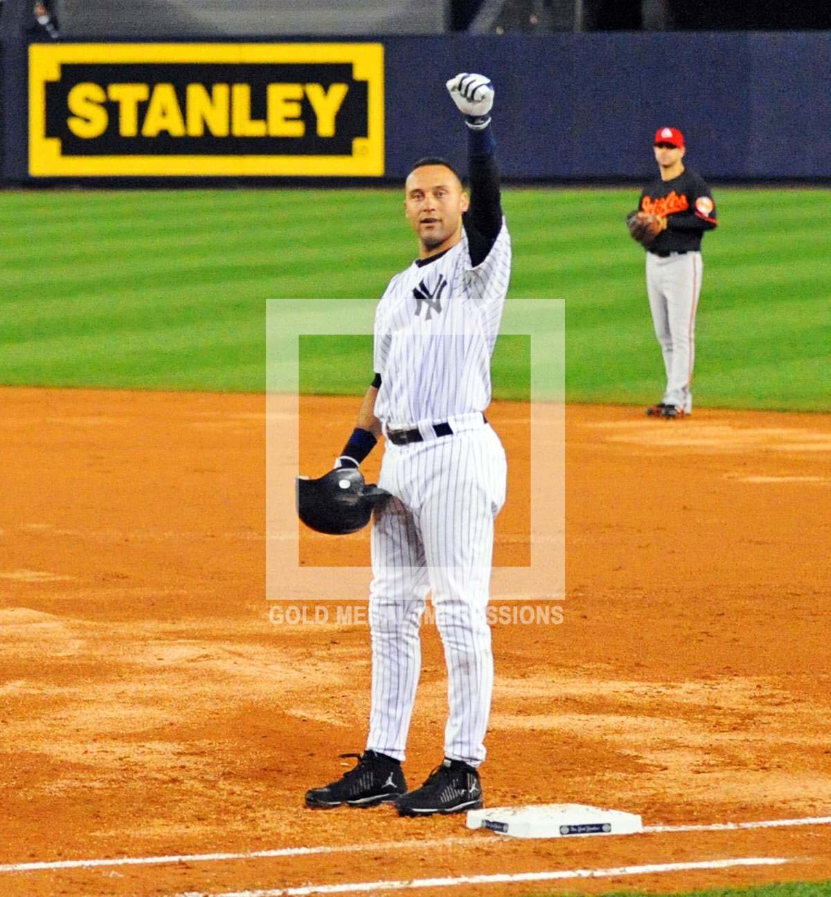Derek Jeter waves to the crowd after breaking Lou Gehrig's franchise hit record in the third inning against the Baltimore Orioles. Derek singled over first base for his 2722nd hit.(AP Photo/Dick Druckman)