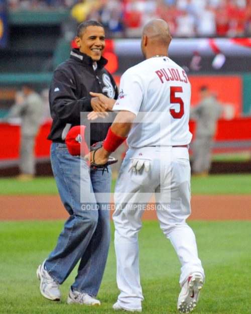 President Barak Obama shakes hands with St. Louis Cardinals first baseman Albert Pulols after throwing out the first ceremonal pitch at the All Star Game. President Obama is the first president to throw out the first pitch at this event since President Gerald Ford did in 1933.(AP Photo/Dick Druckman)