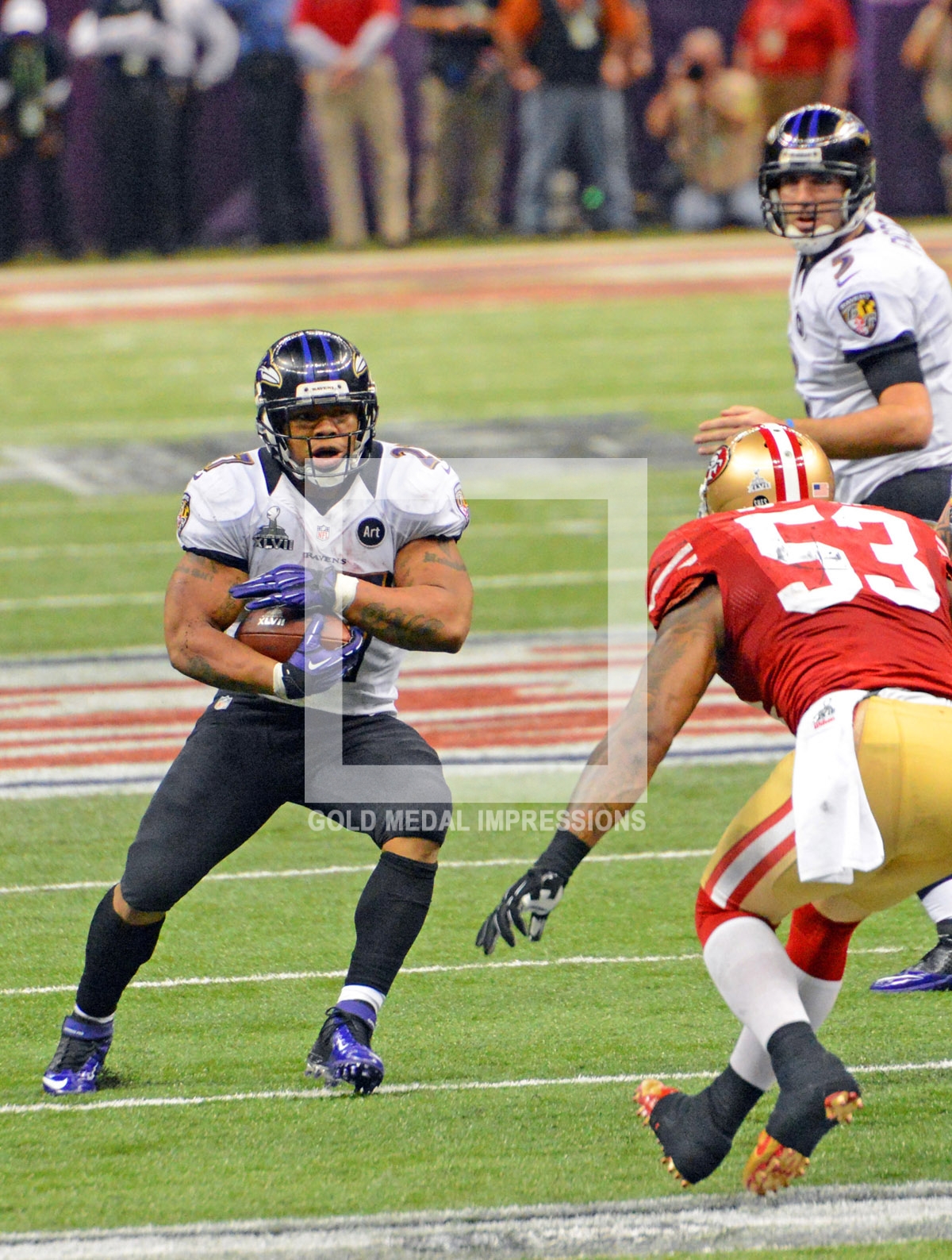 Baltimore Ravens running back Ray Rice runs for a first down in the fourth quarter as San Francisco 49ers linebacker Navorro Bowman comes up to make the tackle.