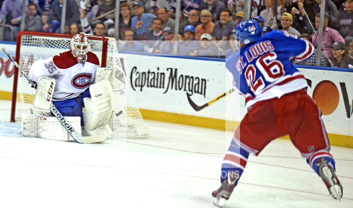 New York Rangers Martin st. Louis scores winning goal against Canadians rookie Dustin Tokarski in overtime giving the Rangers a 3-2 victory. The Rangers now head back to Montre'al leading 3-1 in round 3 of the Stanley Cup Playoffs.(AP Photo/Dick Druckman