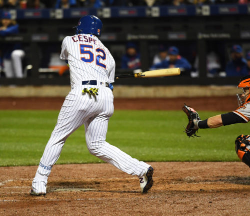 New York Mets outfielder, YOENIS CESPEDES, singles in the third inning, driving in the second of 12 runs scored in the third inning against the San Francisco Giants. The Mets went on to win 13-1.