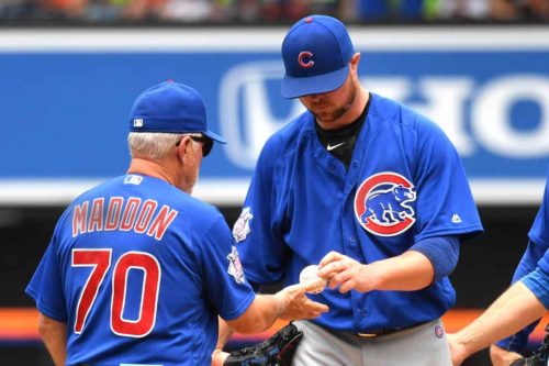 Chicago Cubs starting pitcher JOHN LESTER hands the ball to Cubs Manager JOE MADDON