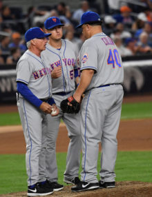 New York Mets starting pitcher BARTOLO COLON hands the ball off to Mets manager TERRY COLLINS