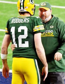 Green Bay Packers head coach MIKE McCARTHY discusses strategy with AARON ROGERS