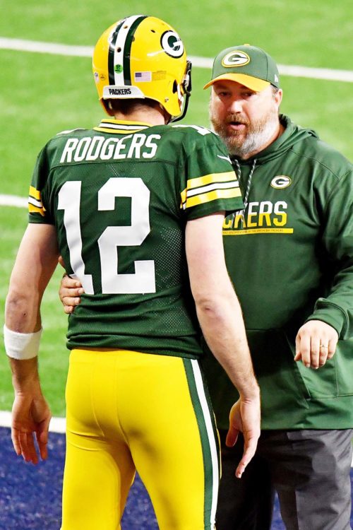 Green Bay Packers head coach MIKE McCARTHY discusses strategy with AARON ROGERS