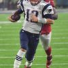 Patriots quarterback Tom Brady runs for a first down