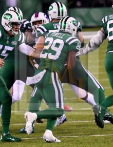 Jets quarterback JOSH MCCOWN hands off to BILAL POWELL