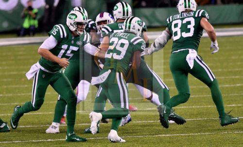 Jets quarterback JOSH MCCOWN hands off to BILAL POWELL