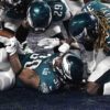 Eagles running back COREY CLEMENT is mobbed by his teammates after scoring