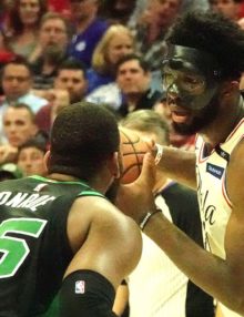 Philadelphia 76ers center Joel Embiid looks into the face of Boston Celtics Greg Monroe