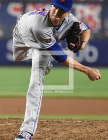 New York Mets starting pitcher Jacob deGrom strikes out Yankees Austin Romine