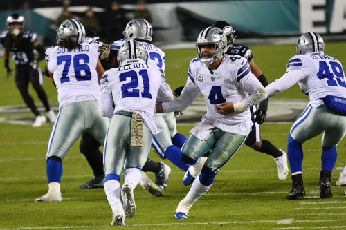 Dallas Cowboys running back Ezekiel Elliot takes a hand-off from quarterback Dak Prescott