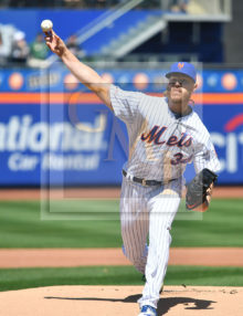 New York Mets starting pitcher, Noah Sydergaard throws the first pitch of the game
