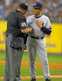 New York Yankees manager Joe Torre has a heart-to-heart talk with the umpire