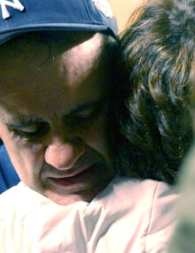 New York Yankees manager Joe Torre hugs his wife after winning AL Championship