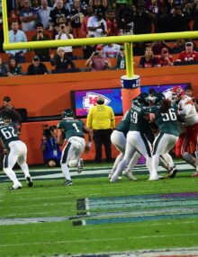 Philadelphia Eagles quarterback, JALEN HURTS, scores a touchdown with JASON KELCE leading the way in the second quarter giving the Eagles a 24-14 lead. The Chiefs rallied in the second half and won 38-35 on a last minute field goal.