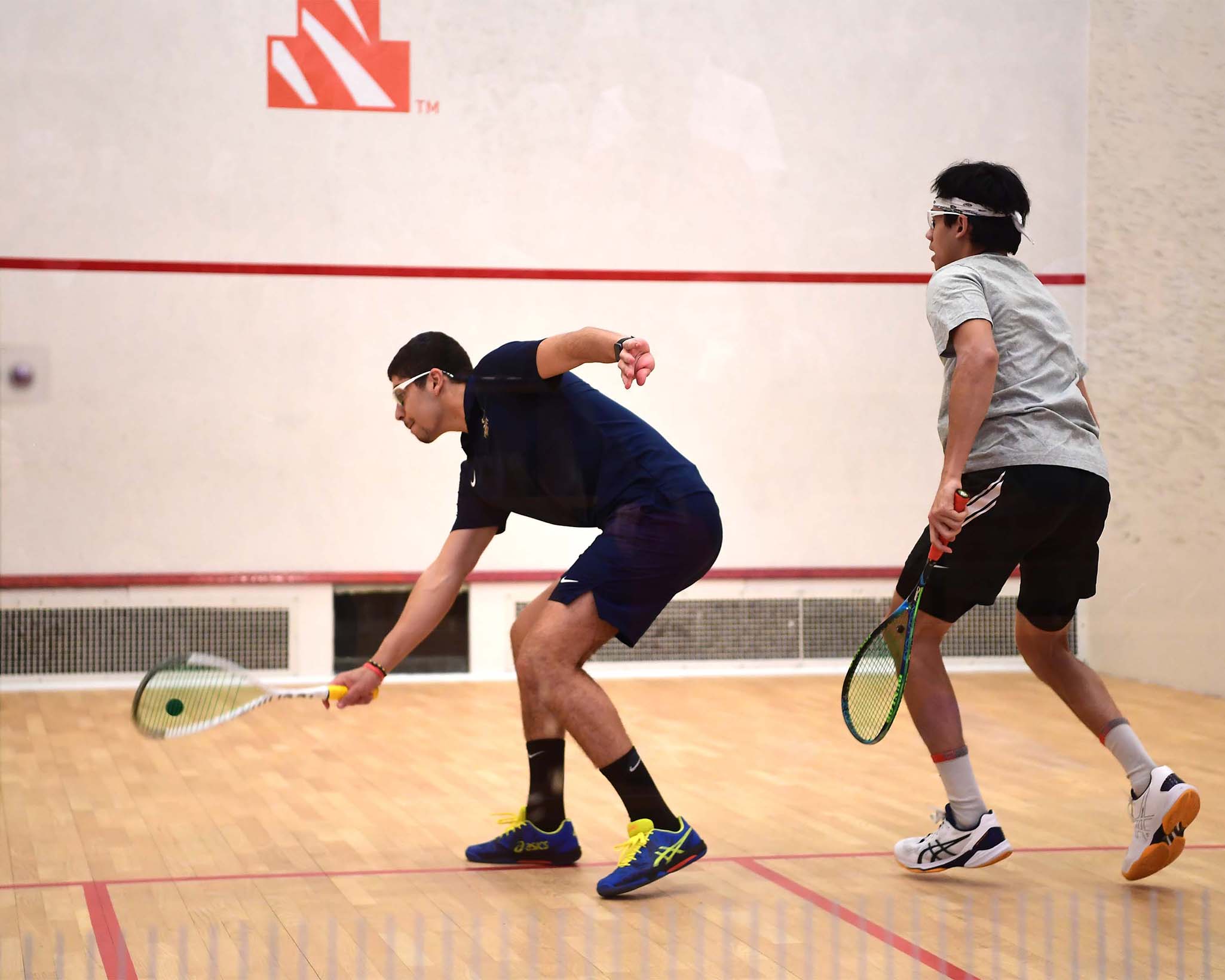 Trinity College's Mohamad Sharaf returns a volley against Princeton University's Daelum Mawji, moving Trinity on to Nationals. One of the many Iconic Images we captured during the Womens & Mens Squash matches between Trinity College and Princeton University which took place January 28th 2023.